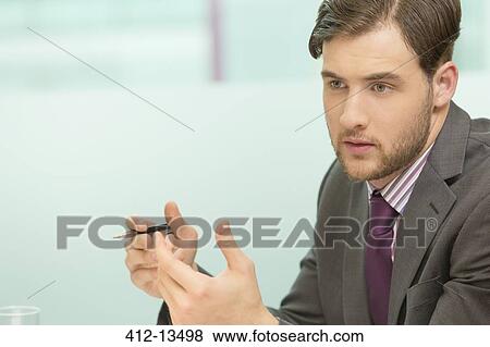 Businessman sitting in office View Large Photo Image Stock Photo - Businessman sitting in office. Fotosearch