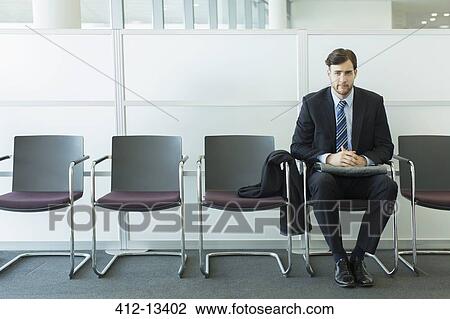 Businessman sitting in waiting area View Large Photo Image Stock Image - Businessman sitting in waiting area. Fotosearch