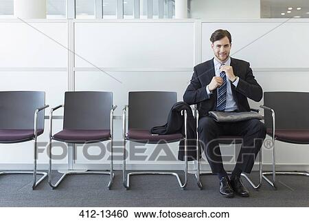 Businessman sitting in waiting area View Large Photo Image Stock Image - Businessman sitting in waiting area. Fotosearch