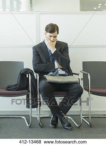 Businessman sitting in waiting area View Large Photo Image Stock Photo - Businessman sitting in waiting area. Fotosearch