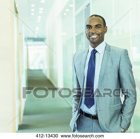 Businessman smiling in office View Large Photo Image Stock Image - Businessman smiling in office. Fotosearch