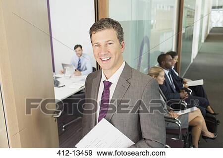 Stock Photo - Businessman smiling in office. Fotosearch