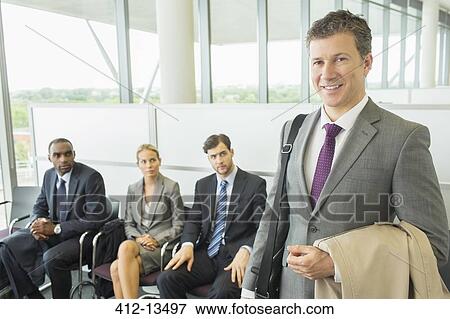Stock Photo - Businessman smiling in office. Fotosearch
