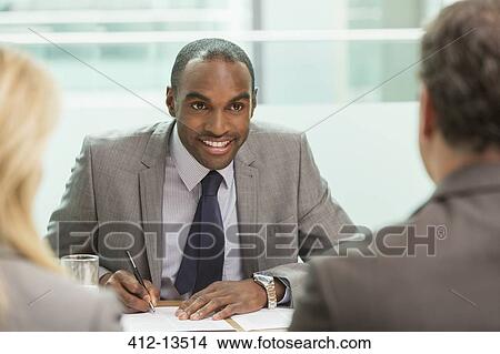 Businessman taking notes in meeting View Large Photo Image Picture - Businessman taking notes in meeting. Fotosearch