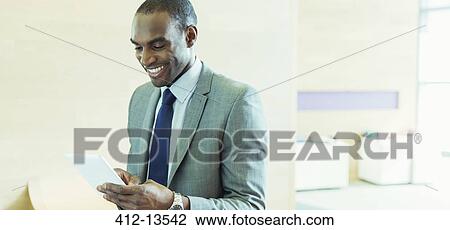Businessman using digital tablet in office View Large Photo Image Stock Image - Businessman using digital tablet in office. Fotosearch