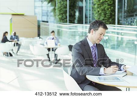 Stock Image - Businessman working in cafe. Fotosearch