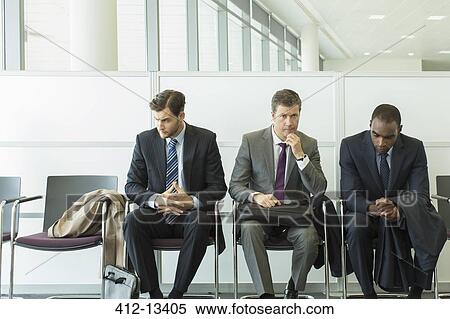 Businessmen sitting in waiting area View Large Photo Image Stock Photography - Businessmen sitting in waiting area. Fotosearch