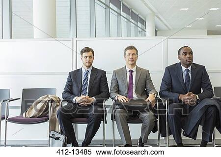 Businessmen sitting in waiting area View Large Photo Image Stock Photography - Businessmen sitting in waiting area. Fotosearch