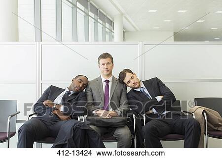 Businessmen sleeping in waiting area View Large Photo Image Picture - Businessmen sleeping in waiting area. Fotosearch