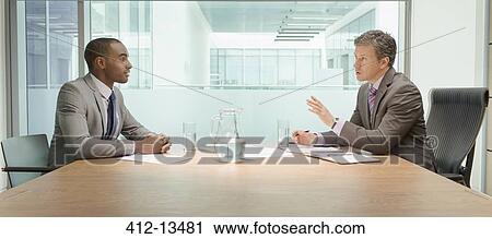 Businessmen talking in meeting View Large Photo Image Stock Image - Businessmen talking in meeting. Fotosearch