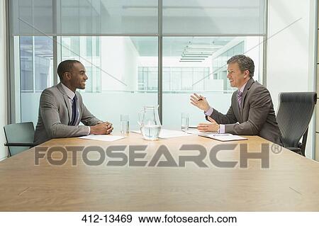 Businessmen talking in meeting View Large Photo Image Stock Photo - Businessmen talking in meeting. Fotosearch