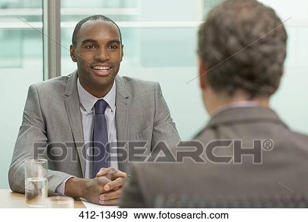 Businessmen talking in meeting View Large Photo Image Stock Photo - Businessmen talking in meeting. Fotosearch