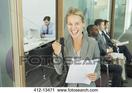 Businesswoman cheering in office View Large Photo Image Stock Image - Businesswoman cheering in office. Fotosearch