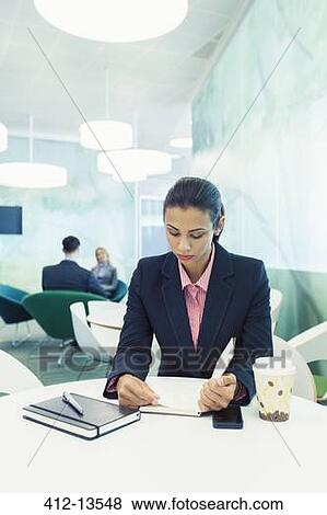 Stock Photo - Businesswoman reading in cafe. Fotosearch
