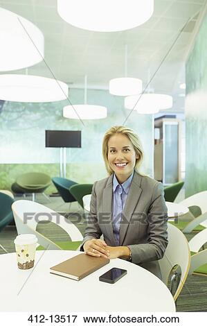 Businesswoman sitting in office View Large Photo Image Stock Photo - Businesswoman sitting in office. Fotosearch