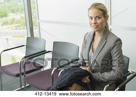 Businesswoman sitting in waiting area View Large Photo Image Stock Photo - Businesswoman sitting in waiting area. Fotosearch