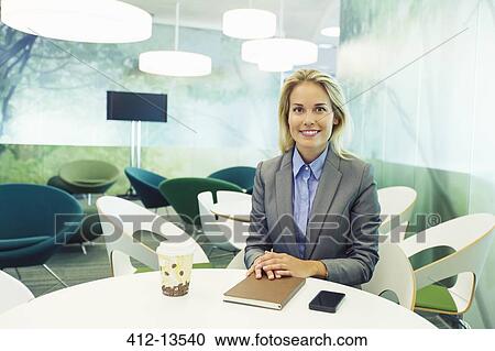 Businesswoman smiling in cafe View Large Photo Image Stock Image - Businesswoman smiling in cafe. Fotosearch