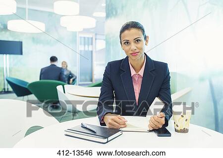 Stock Photograph - Businesswoman smiling in cafe. Fotosearch
