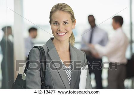 Businesswoman smiling in office View Large Photo Image Stock Photo - Businesswoman smiling in office. Fotosearch