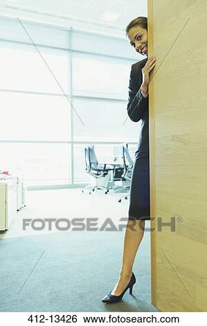 Businesswoman smiling in office View Large Photo Image Stock Photograph - Businesswoman smiling in office. Fotosearch