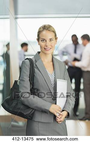 Businesswoman smiling in office View Large Photo Image Stock Photography - Businesswoman smiling in office. Fotosearch