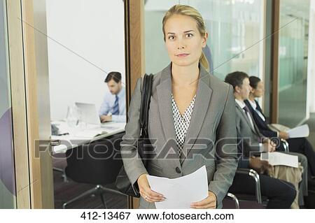 Stock Photo - Businesswoman standing in office. Fotosearch