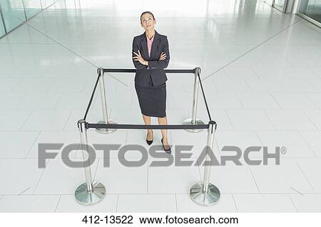 Businesswoman standing in roped-off square View Large Photo Image Stock Image - Businesswoman standing in roped-off square. Fotosearch