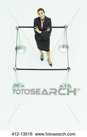 Businesswoman standing in roped-off square View Large Photo Image Stock Photograph - Businesswoman standing in roped-off square. Fotosearch