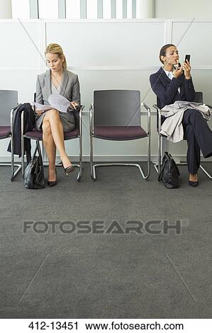 Businesswomen sitting in waiting area View Large Photo Image Stock Image - Businesswomen sitting in waiting area. Fotosearch