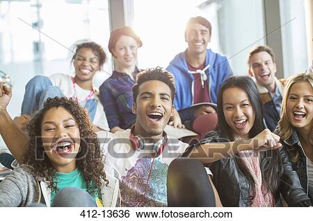 Friends cheering together indoors View Large Photo Image Stock Photograph - Friends cheering together indoors. Fotosearch