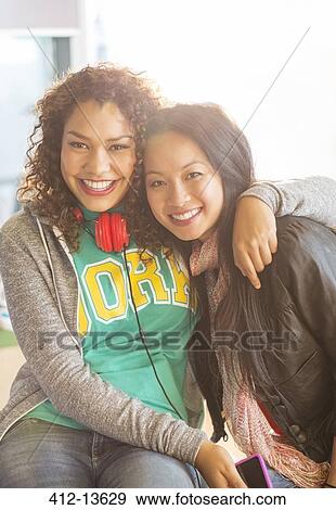 Friends smiling and hugging View Large Photo Image Stock Photo - Friends smiling and hugging. Fotosearch
