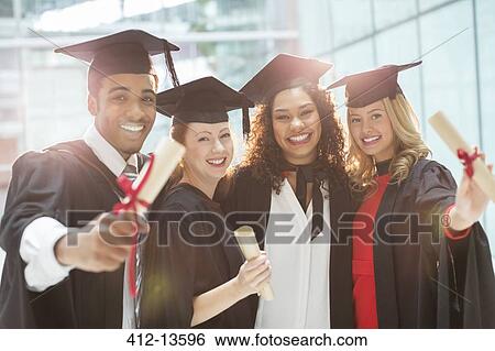 Graduates smiling with diploma View Large Photo Image Stock Photograph - Graduates smiling with diploma. Fotosearch