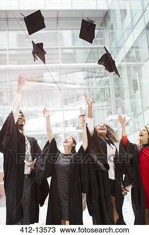 Graduates tossing caps in air View Large Photo Image Stock Image - Graduates tossing caps in air. Fotosearch