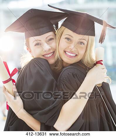 Smiling graduates hugging View Large Photo Image Stock Image - Smiling graduates hugging. Fotosearch