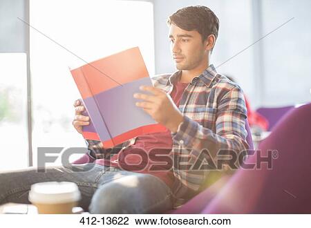 Student reading textbook in cafe View Large Photo Image Stock Image - Student reading textbook in cafe. Fotosearch