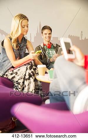 Students using cell phones in lounge View Large Photo Image Stock Image - Students using cell phones in lounge. Fotosearch