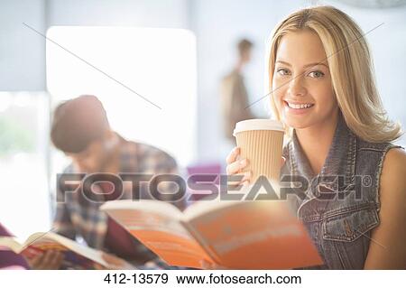 Stock Photo - University student reading and drinking coffee. Fotosearch