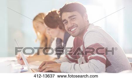 Stock Photo - University student smiling in classroom. Fotosearch