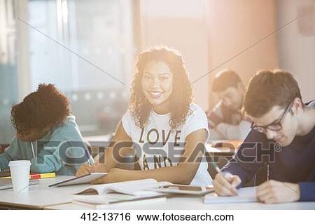 Stock Photograph - University student smiling in classroom. Fotosearch