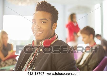 Stock Photo - University student smiling in lounge. Fotosearch