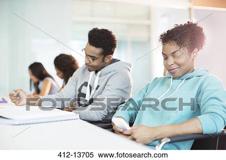 University student using cell phone in classroom View Large Photo Image Stock Photography - University student using cell phone in classroom. Fotosearch