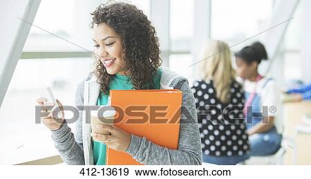 University student using cell phone View Large Photo Image Stock Photo - University student using cell phone. Fotosearch