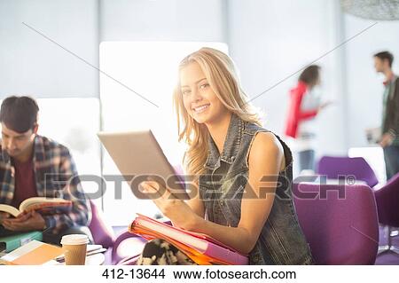 University student using digital tablet in lounge View Large Photo Image Picture - University student using digital tablet in lounge. Fotosearch