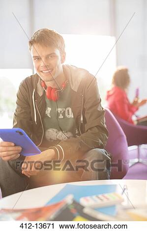 University student using digital tablet in lounge View Large Photo Image Stock Image - University student using digital tablet in lounge. Fotosearch