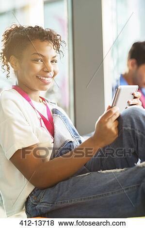 Stock Photo - University student using digital tablet. Fotosearch