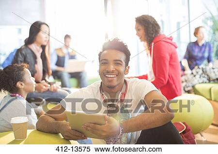 University student using digital tablet in lounge View Large Photo Image Stock Photography - University student using digital tablet in lounge. Fotosearch
