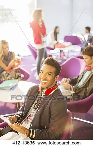 University student using digital tablet in lounge View Large Photo Image Stock Photography - University student using digital tablet in lounge. Fotosearch