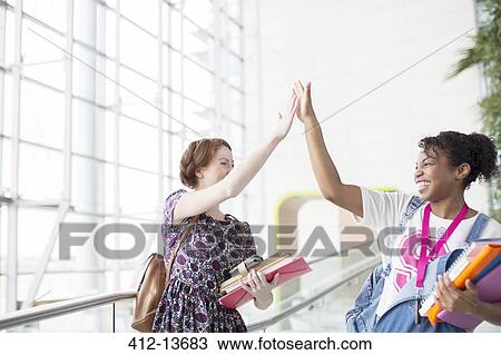 University students high fiving indoors View Large Photo Image Stock Image - University students high fiving indoors. Fotosearch