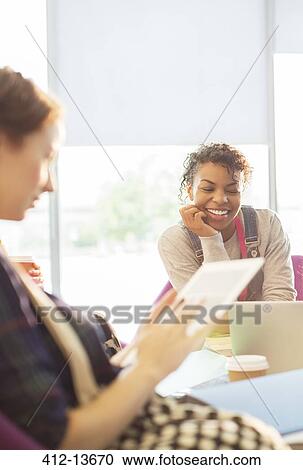 Stock Image - University students relaxing in lounge. Fotosearch