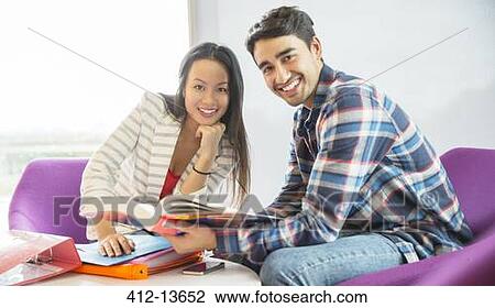Stock Image - University students talking in lounge. Fotosearch